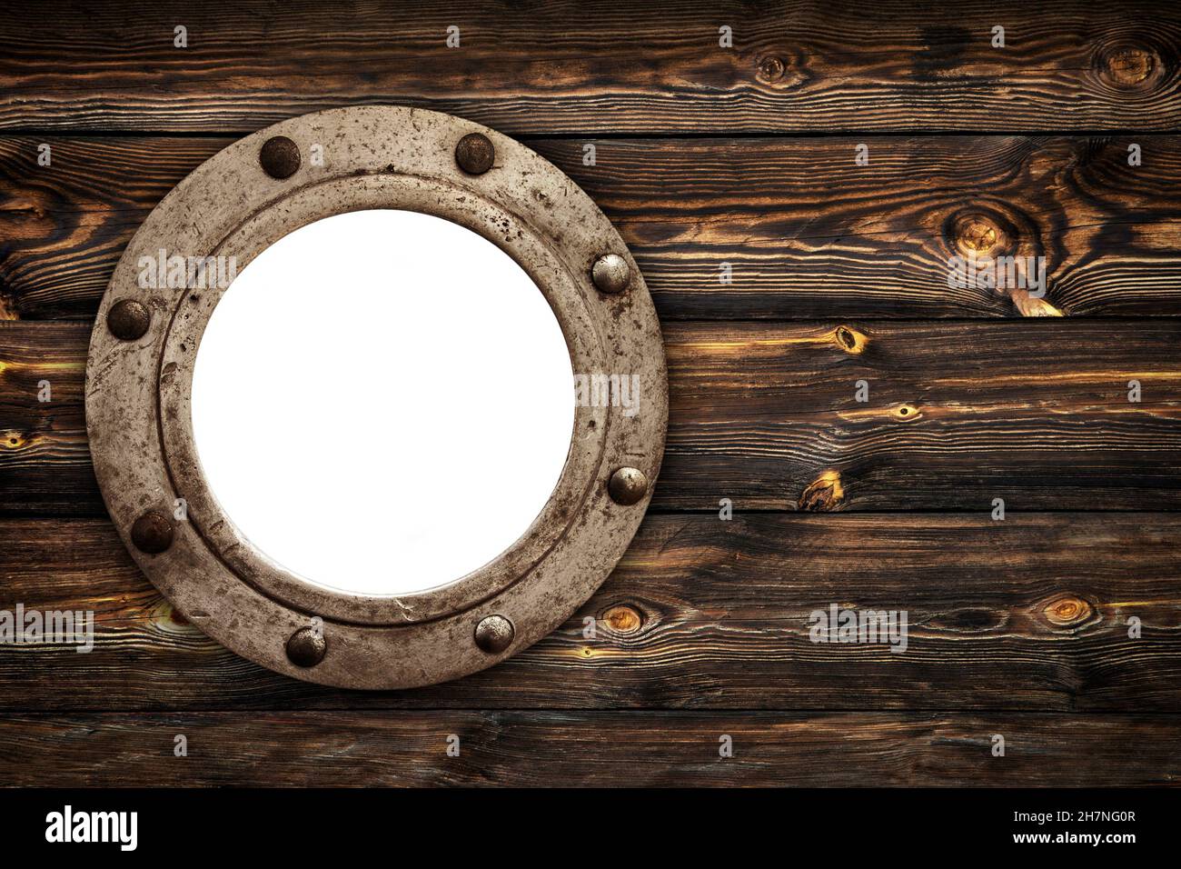 Close-up of an old rusty closed empty porthole window. Old rich wood