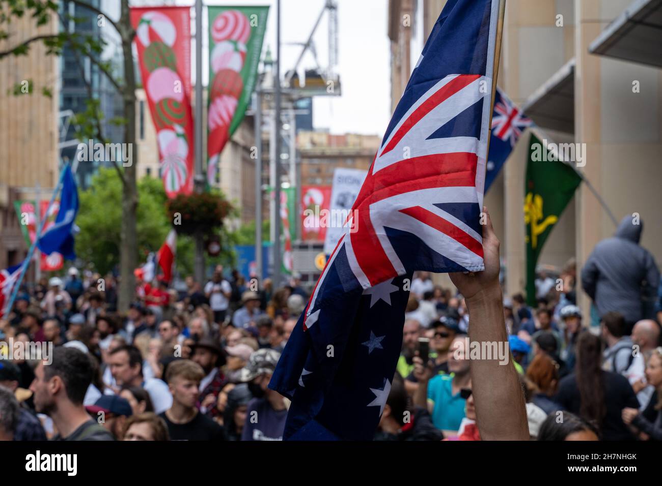 Protest rally against government policies in Australia, Sydney, Martin Place 20 Nov 2021. People holding Australian flag. Stock Photo