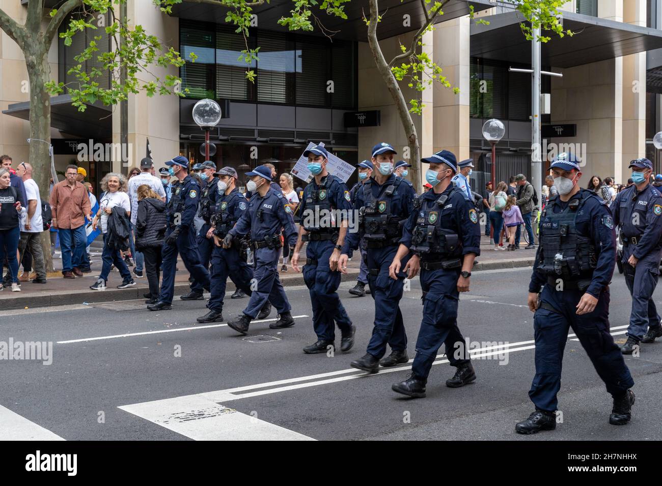 Several policemen and policewomen can be seen walking on the street in Sydney, Australia. part of the freedom rally protest against vaccine mandates. Stock Photo