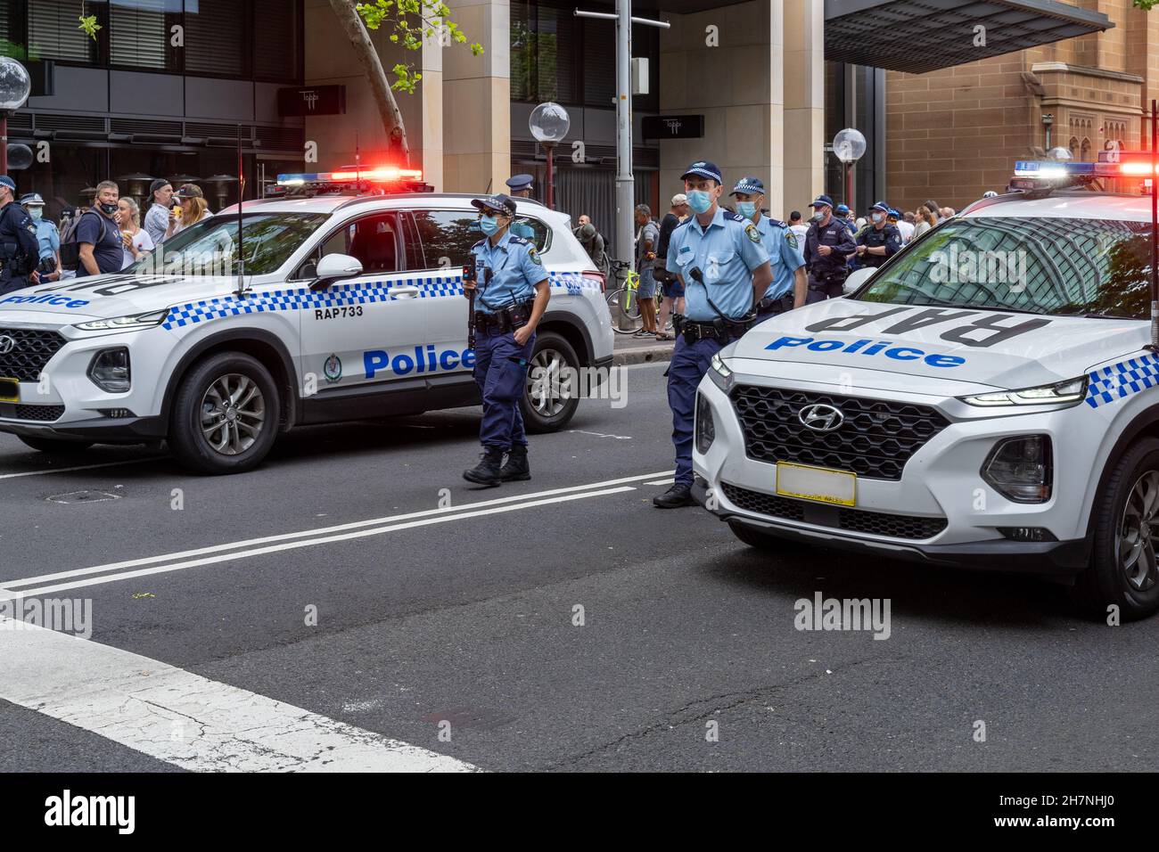 Police officers with police vehicles on patrol Sydney Australia during anti vaccine protest against government mandates. Stock Photo