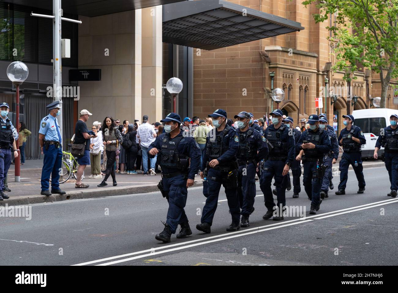 Several police officers and constables can be seen walking on the street in Sydney, Australia. at protest against government vaccine mandates. Stock Photo