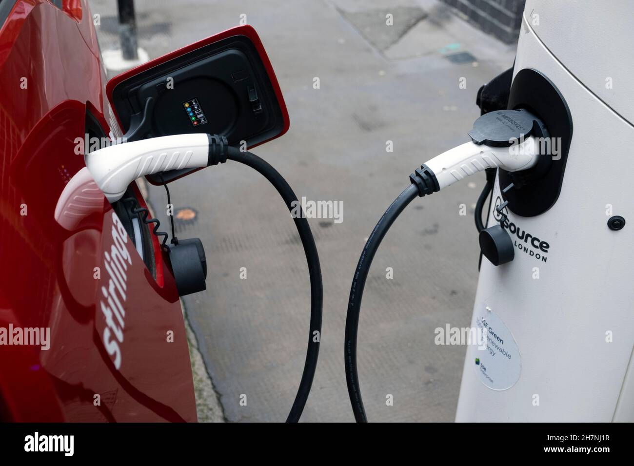 Car recharging at EV charge station on street in East London UK Stock Photo