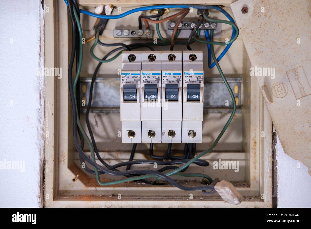 Castelo Branco, Portugal - November 16 2021: 4 Hager C16 Circuit breakers mounted dangerously in a fuse box Stock Photo