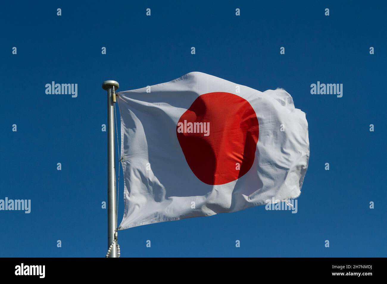 Japanese flag, known as the Hinomaru flying on a flagpole in Kanagawa, Japan. Stock Photo