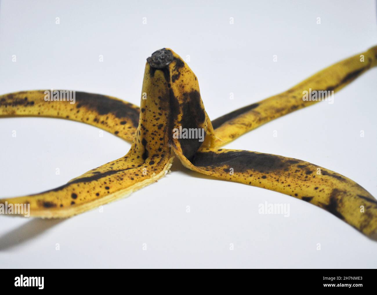 Skin of a ripe banana set against a white background Stock Photo