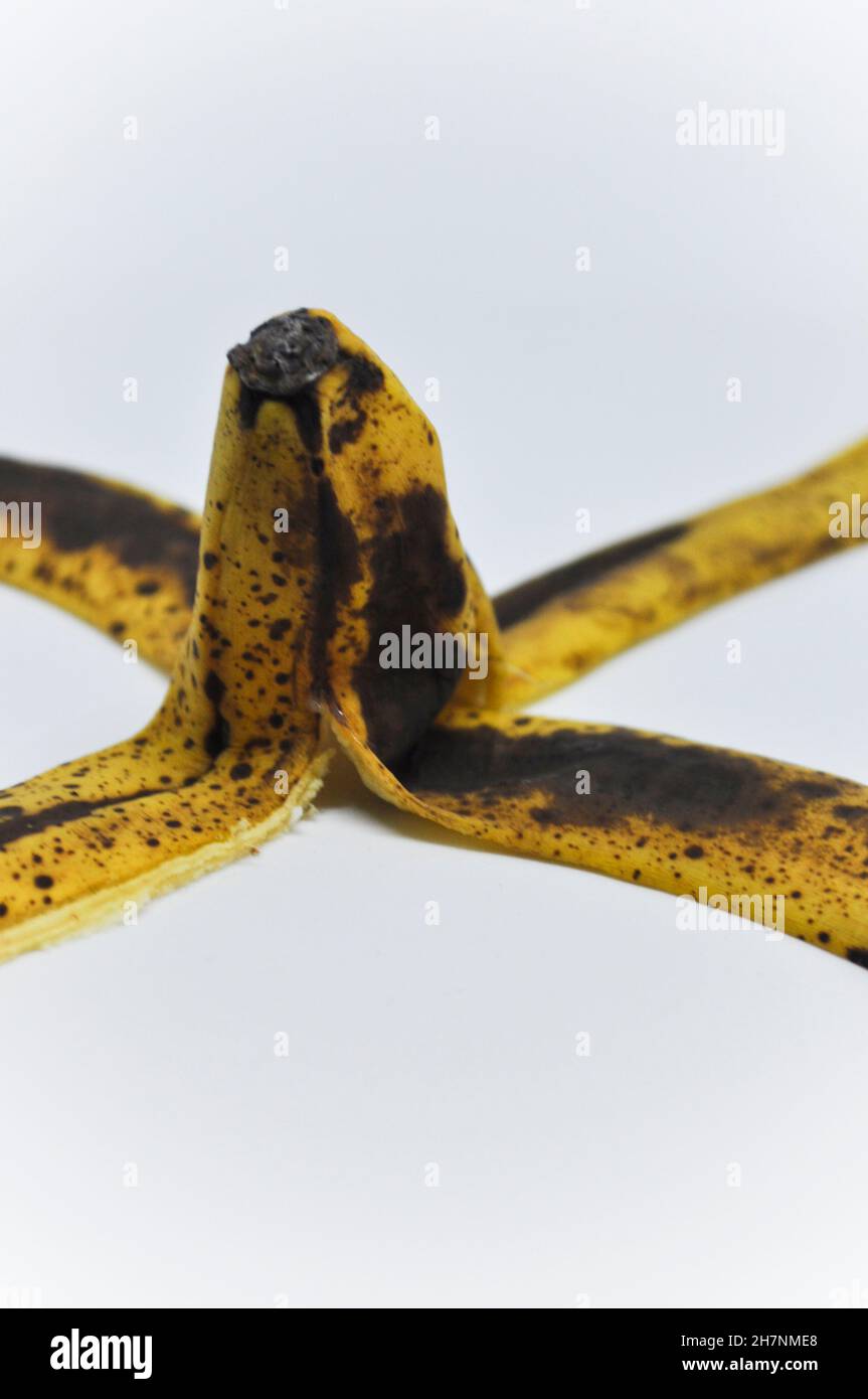 Skin of a ripe banana set against a white background Stock Photo