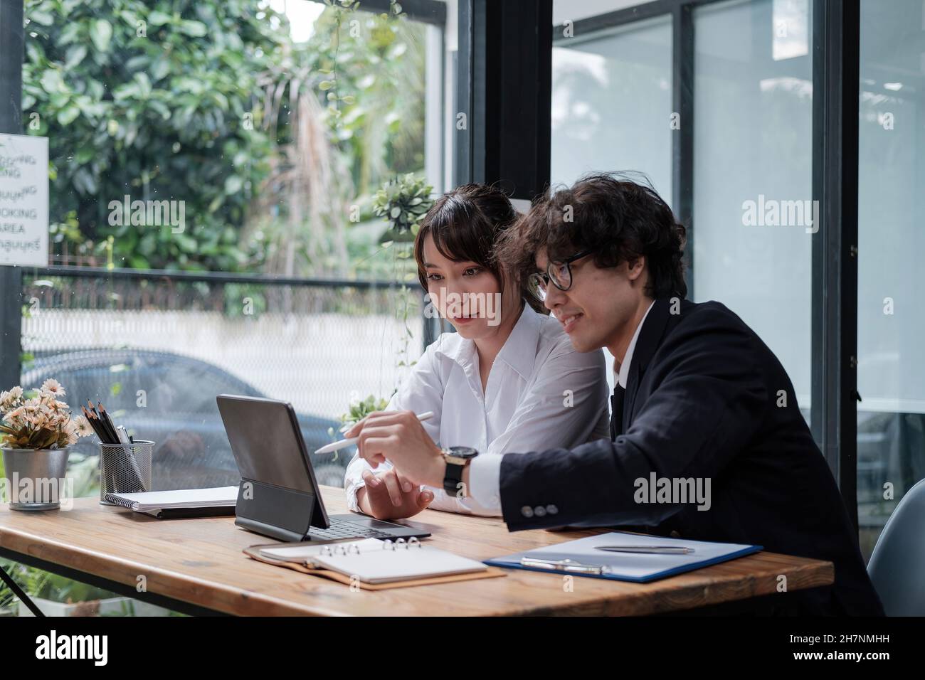 University asian students learning language using digital tablet and internet, working project together. Exam preparation. Online education concept Stock Photo