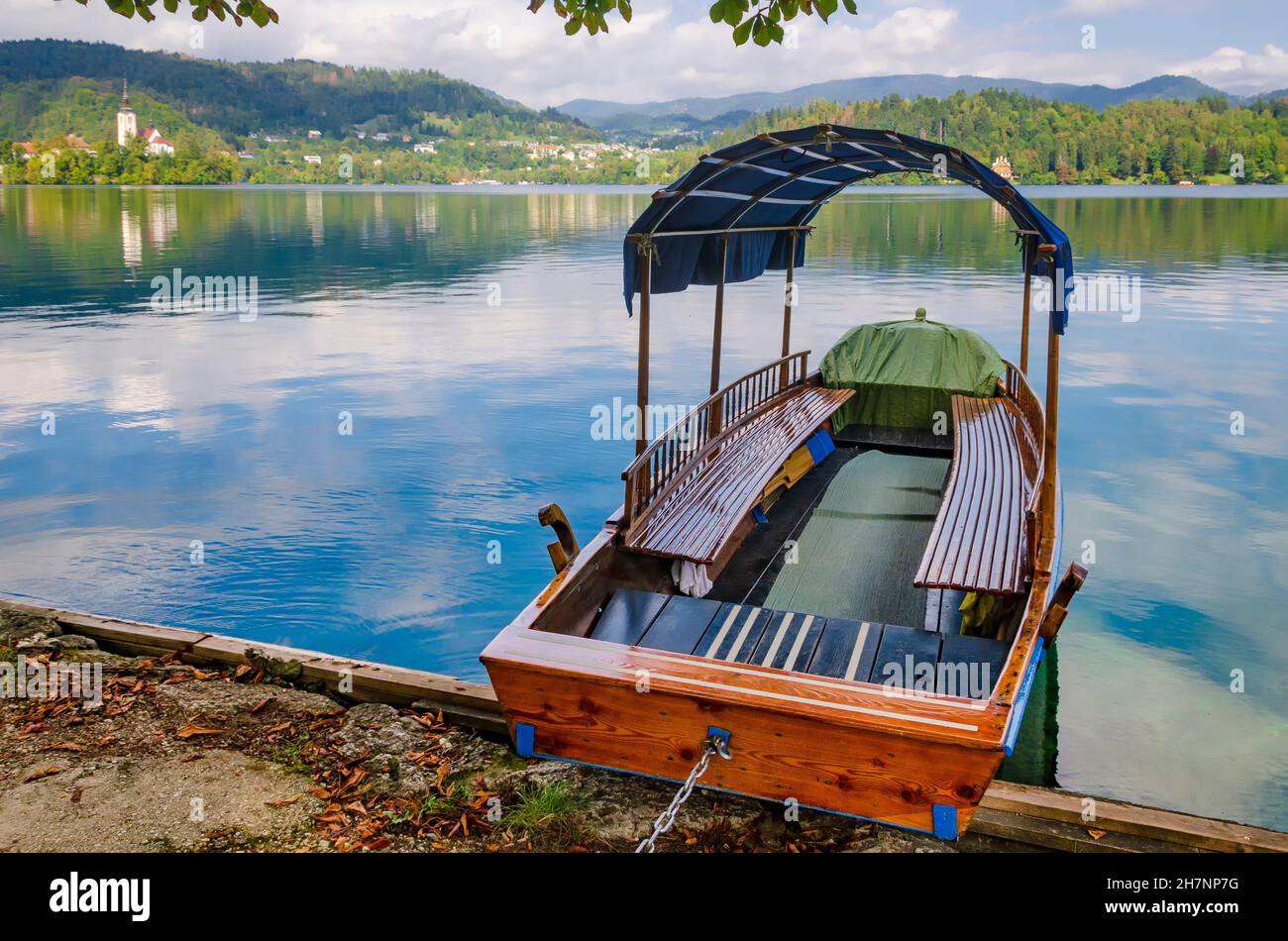 Tourist boat on the Bled Lake. Empty rent boat on a pier. No tourists in Slovenia due to coronavirus lockdown and quarantine Stock Photo