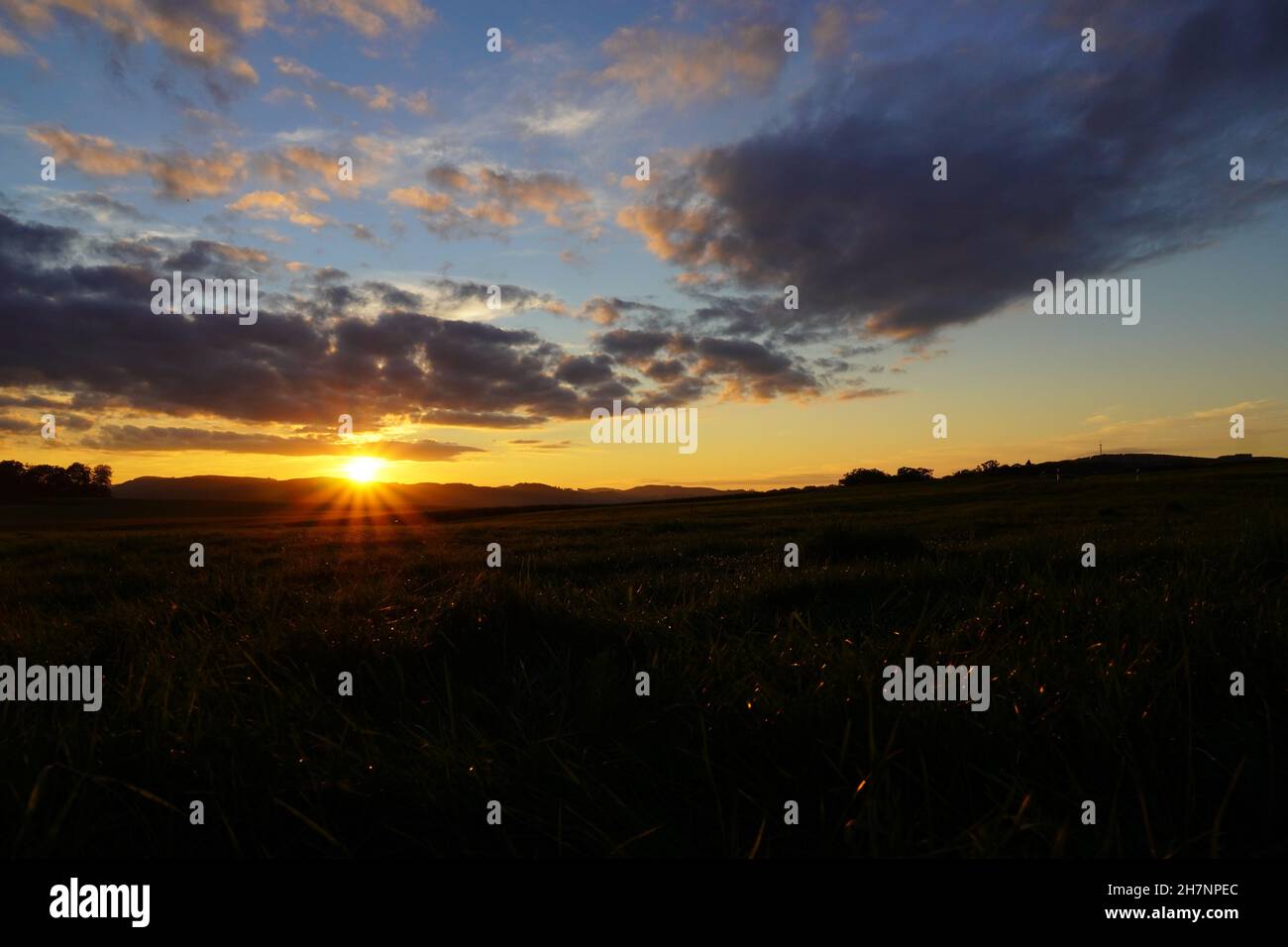 Sunset in the Sauerland. Landscape with setting sun in the evening. Stock Photo