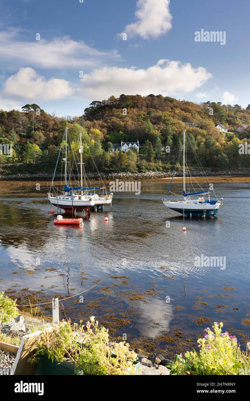Yachts moored at low tide in gairloch harbour in autumn sunshine, North West Scotland, UK. Stock Photo