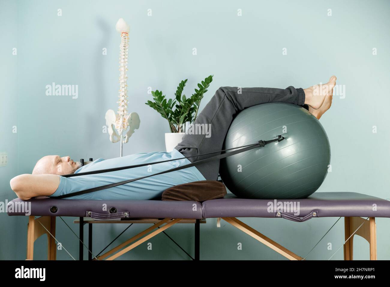 A man lying on the massage table in constructive rest postion, si joint