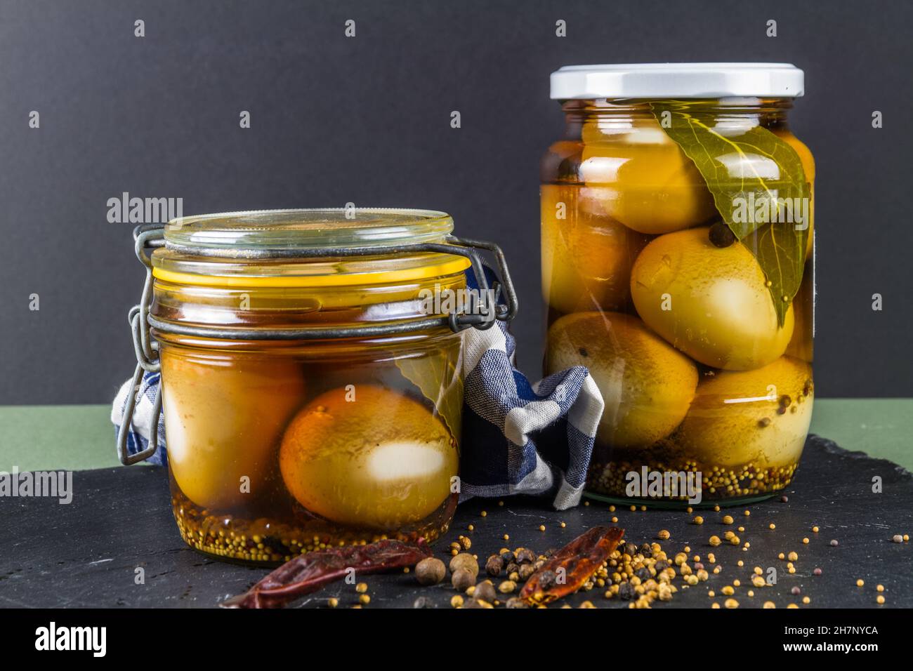 Two jars of eggs pickled in dark malt vinegar, landscape Stock Photo