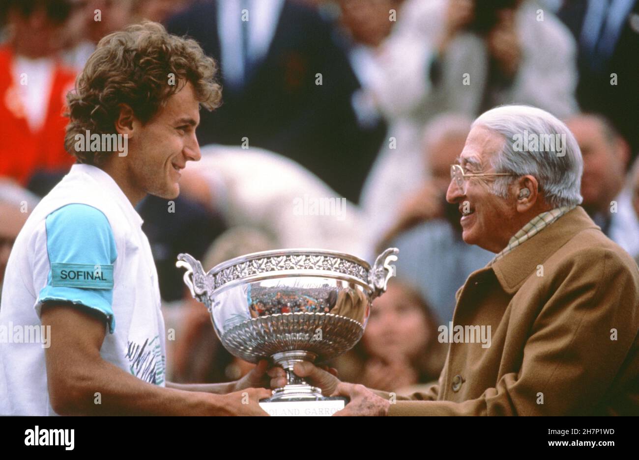 Swedish tennis player Mats Wilander receiving the Coupe des Mousquetaires from René Lacoste, after his victory in the men's singles final of the French Open tournament. Paris, Roland Garros, June 5, 1988 Stock Photo