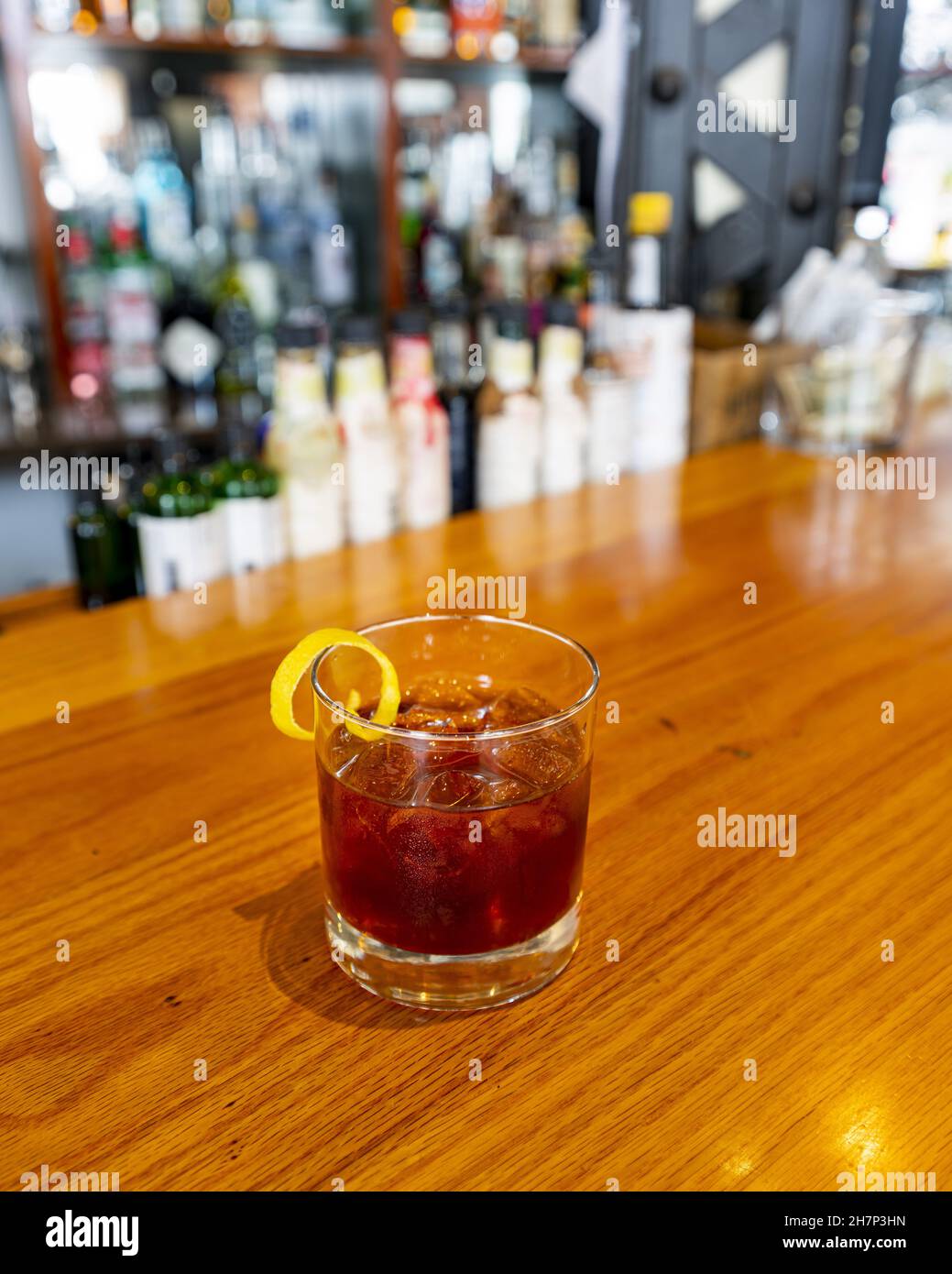 Stunning rum cocktail at a small speakeasy with a background of bitters