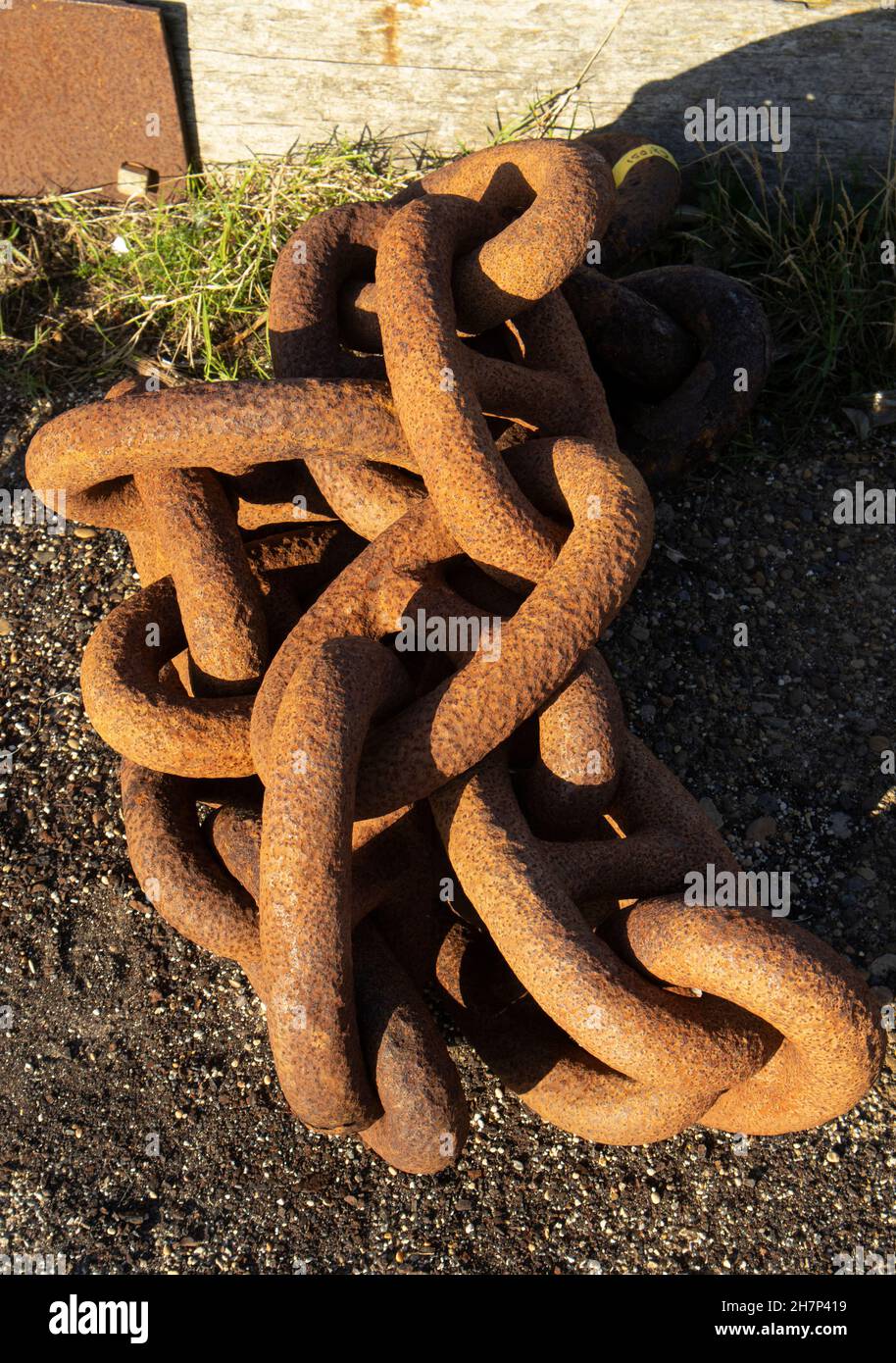 Rusty old anchor chains make an interesting study of colour and texture. Seldom discarded they will be resourced to other tasks and purposes Stock Photo
