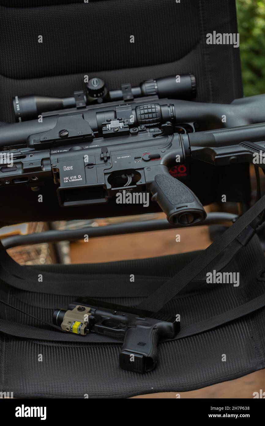 Close-up of parts of automatic weapon with selective focus and blurred ...