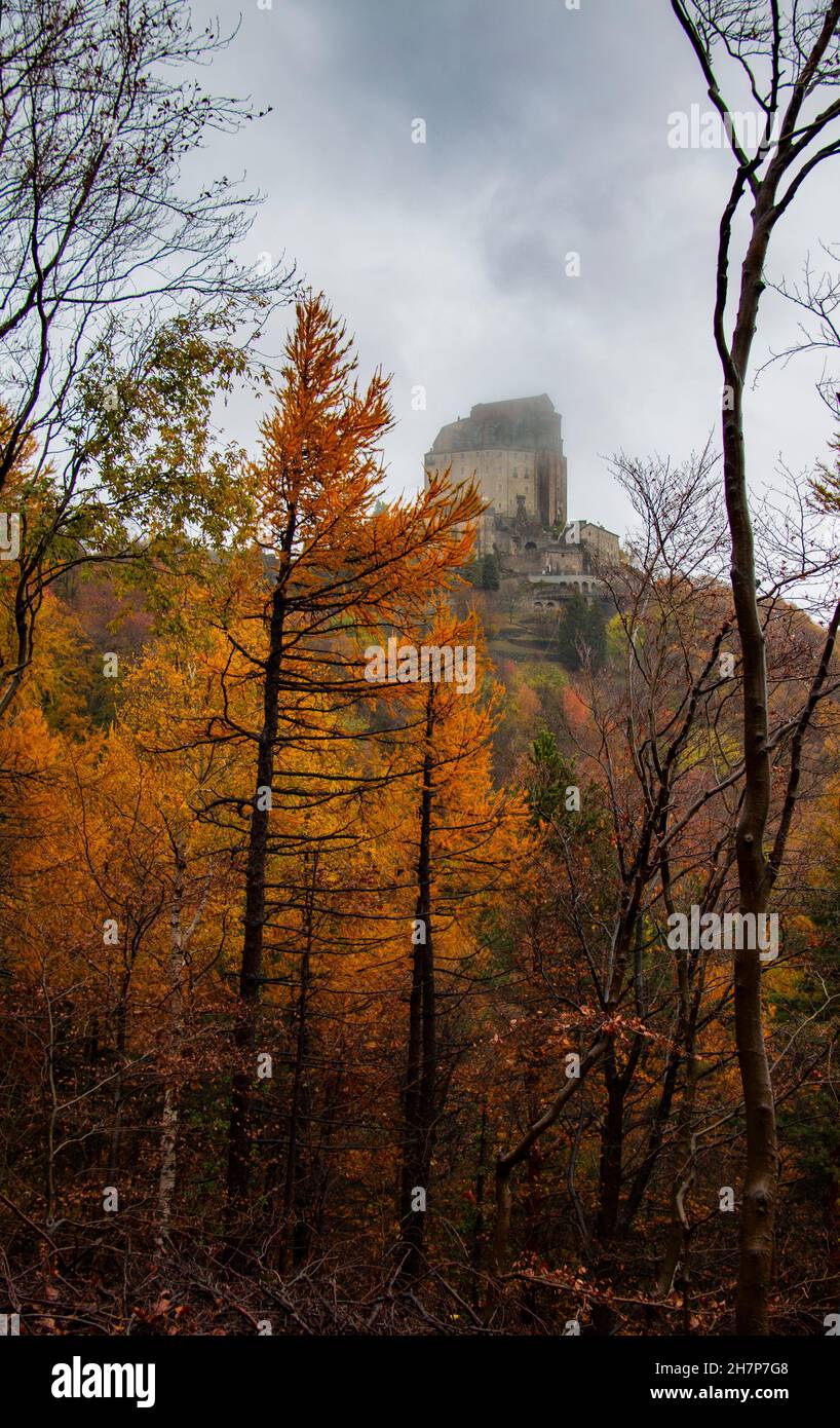 Sacre di San Michele perched on the hillside of Monte Pirchiriano, in the foothills of the Italian Alps, on a misty morning - San Pietro, Turin, Italy Stock Photo