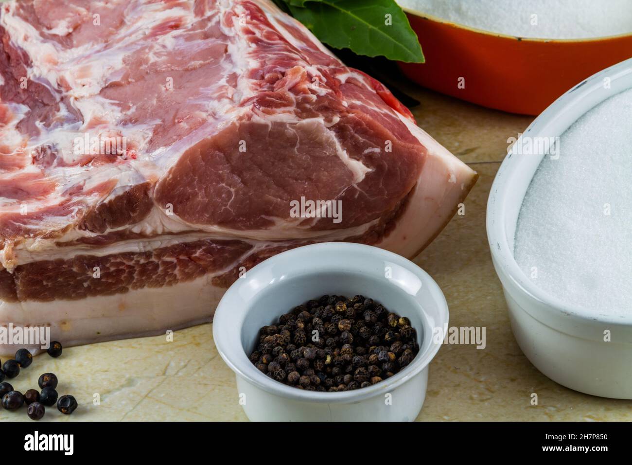 Pork loin or back joint with ingredients for dry curing into bacon