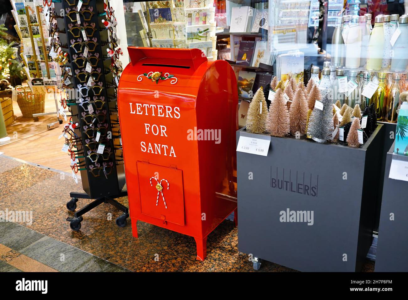 A red 'Letters for Santa' letterbox along with Christmas decoration in front of a Butler's store in Düsseldorf/Germany. Stock Photo