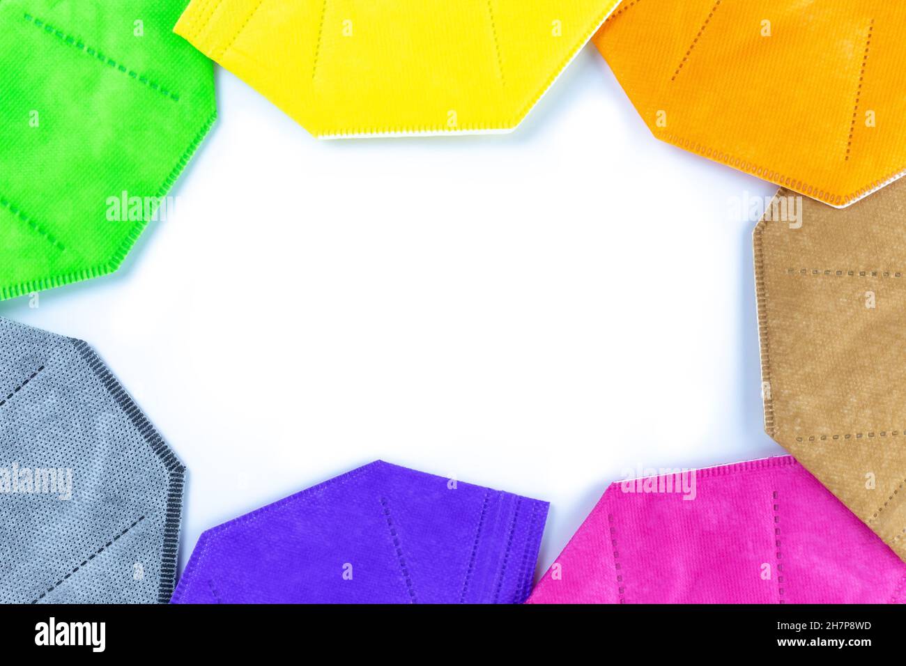A Copy space round stack of  different colors face masks respirators Copy space on white background. Top view flat layer. Protection from covid virus Stock Photo