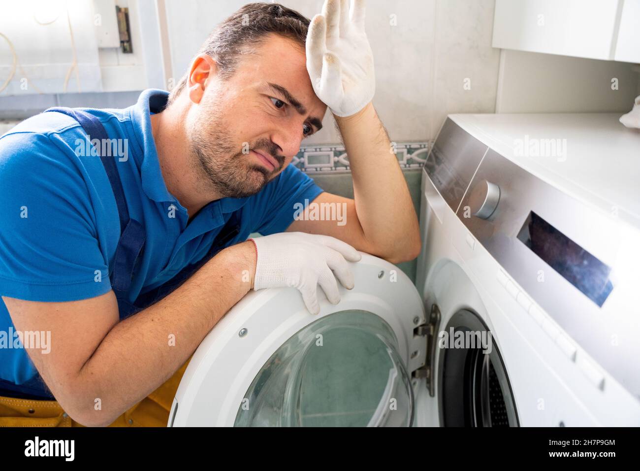 One expert repairman fixing a broken washing machine Stock Photo Alamy