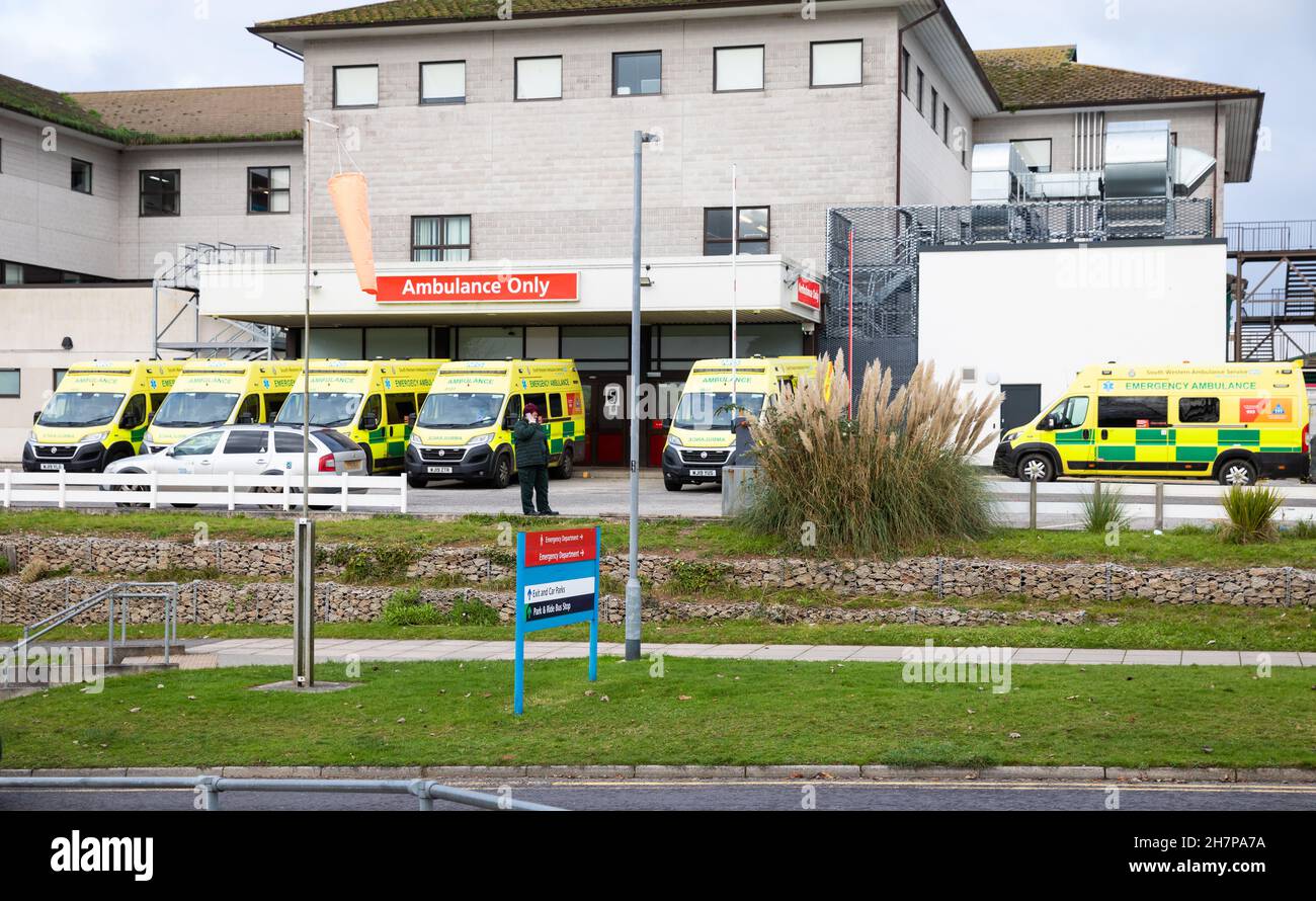 Truro, UK,24th November 2021,Ambulances wait outside A & E at The Royal Cornwall Hospital in Treliske, Truro. Patients are having to wait their turn which can be many hours to be taken in to A&E to be seen. This is caused by a backlog of patients in the hospital being unable to be discharged back into the community when they are ready to be discharged along with extra strain on beds due to Covid-19.Credit: Keith Larby/Alamy Live News Stock Photo