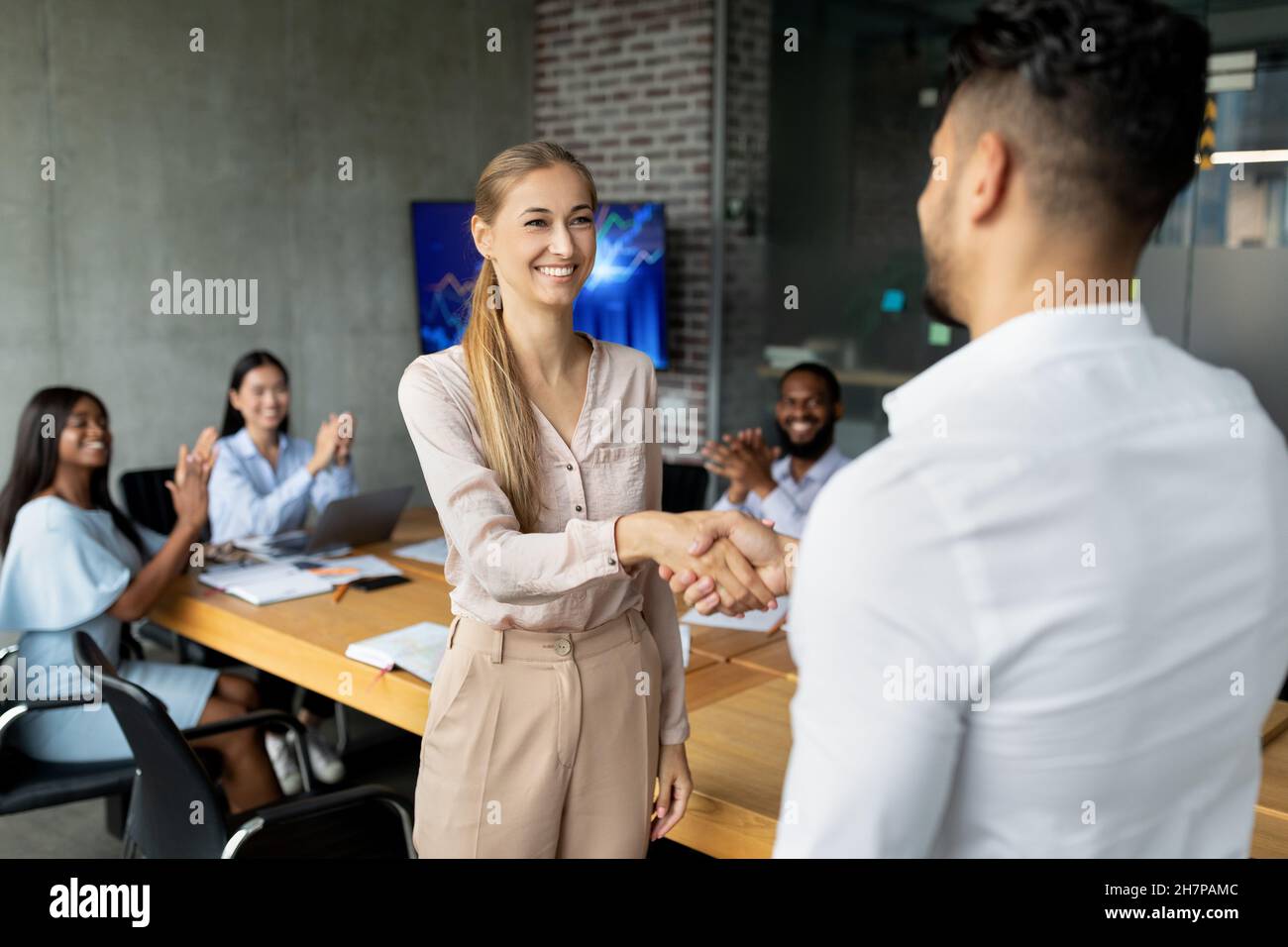 Welcome To Team. Boss Shaking Hands With New Female Employee In Office Stock Photo