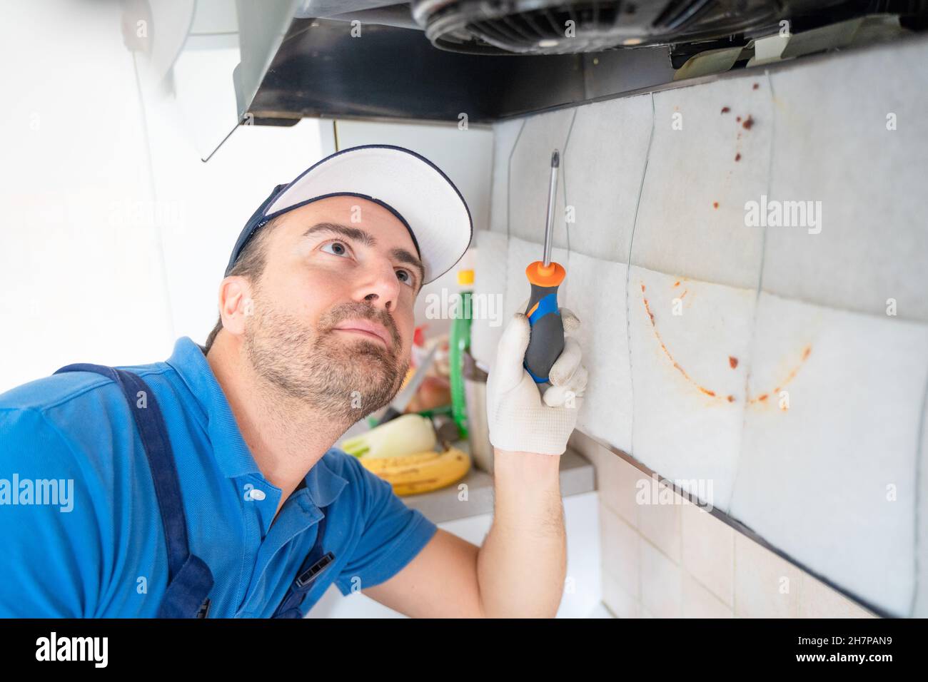 One repairman cleaning a kitchen hood air filter Stock Photo