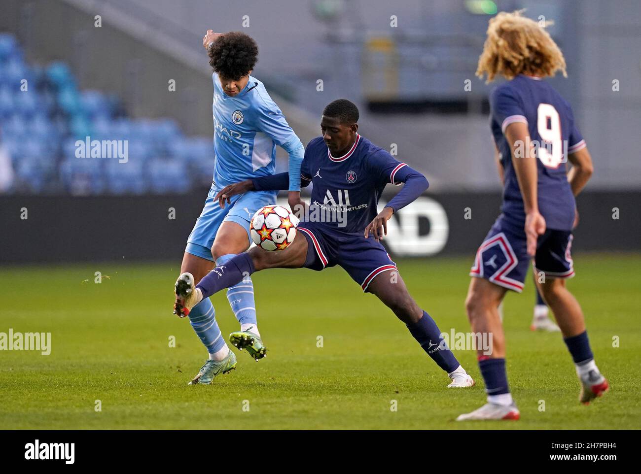 Manchester City's Nico O'Reilly (left) and Paris Saint Germain's Ayman Kari battle for the ball during the UEFA Youth League, Group A match at the Manchester City Academy Stadium, Manchester. Picture date: Wednesday November 24, 2021. Stock Photo