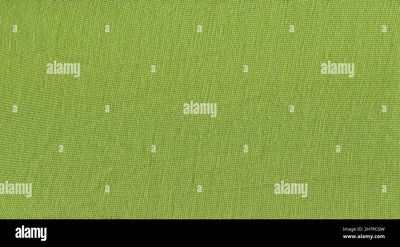 Green knitting wool texture full frame. Knitted green texture surface close up. Stock Photo