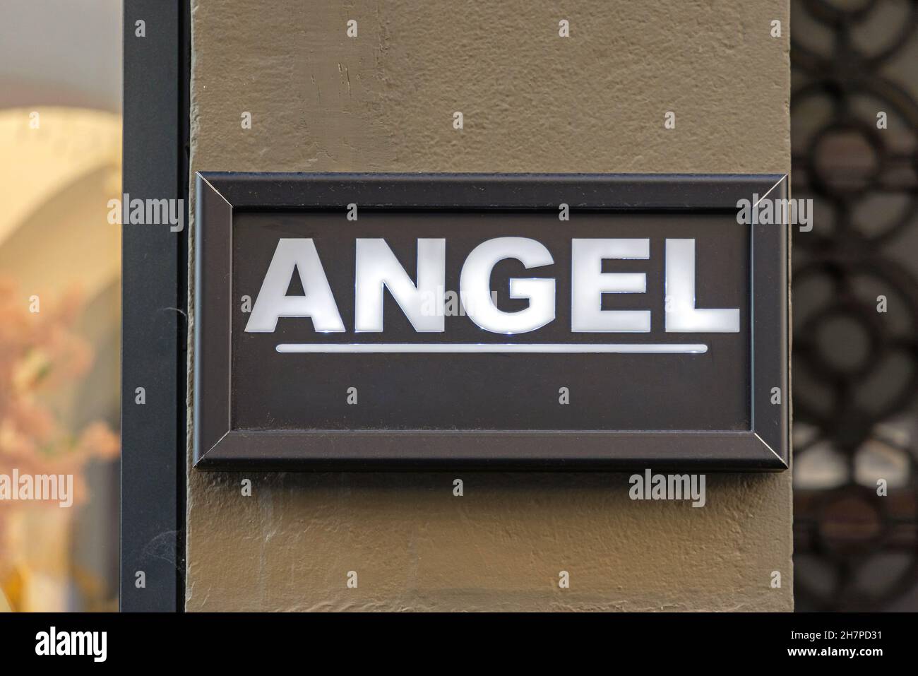 Illuminated Sign Angel in Black Frame at Wall Stock Photo