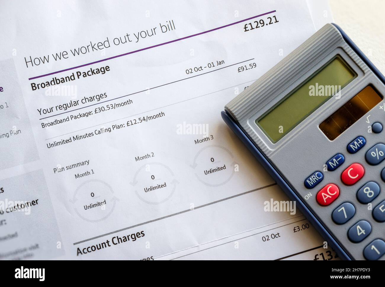 Concept image of an itemised combined broadband and telephone line rental bill with electronic calculator Stock Photo