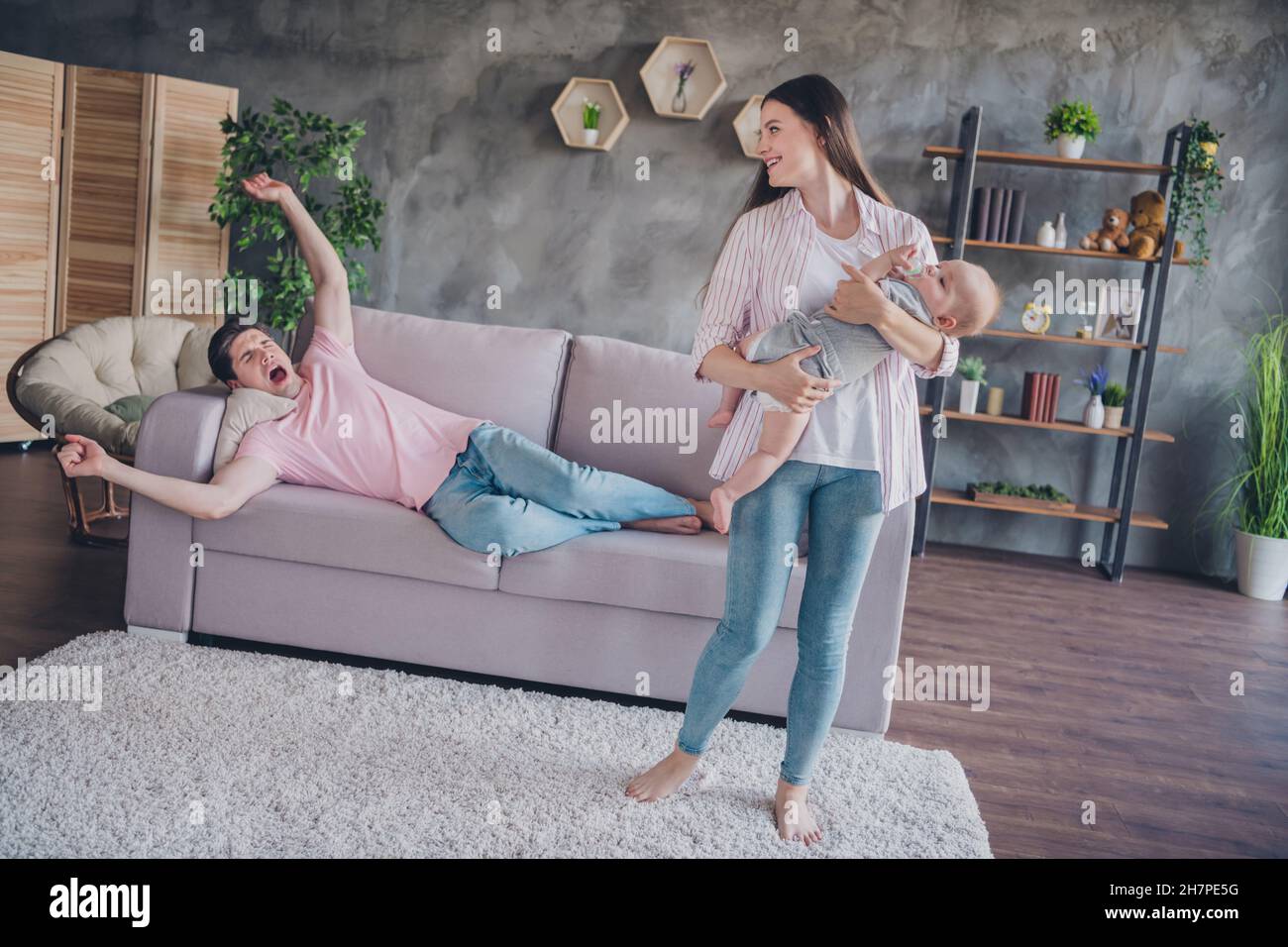 Portrait of attractive nice cheerful family mommy daddy holding rocking ...