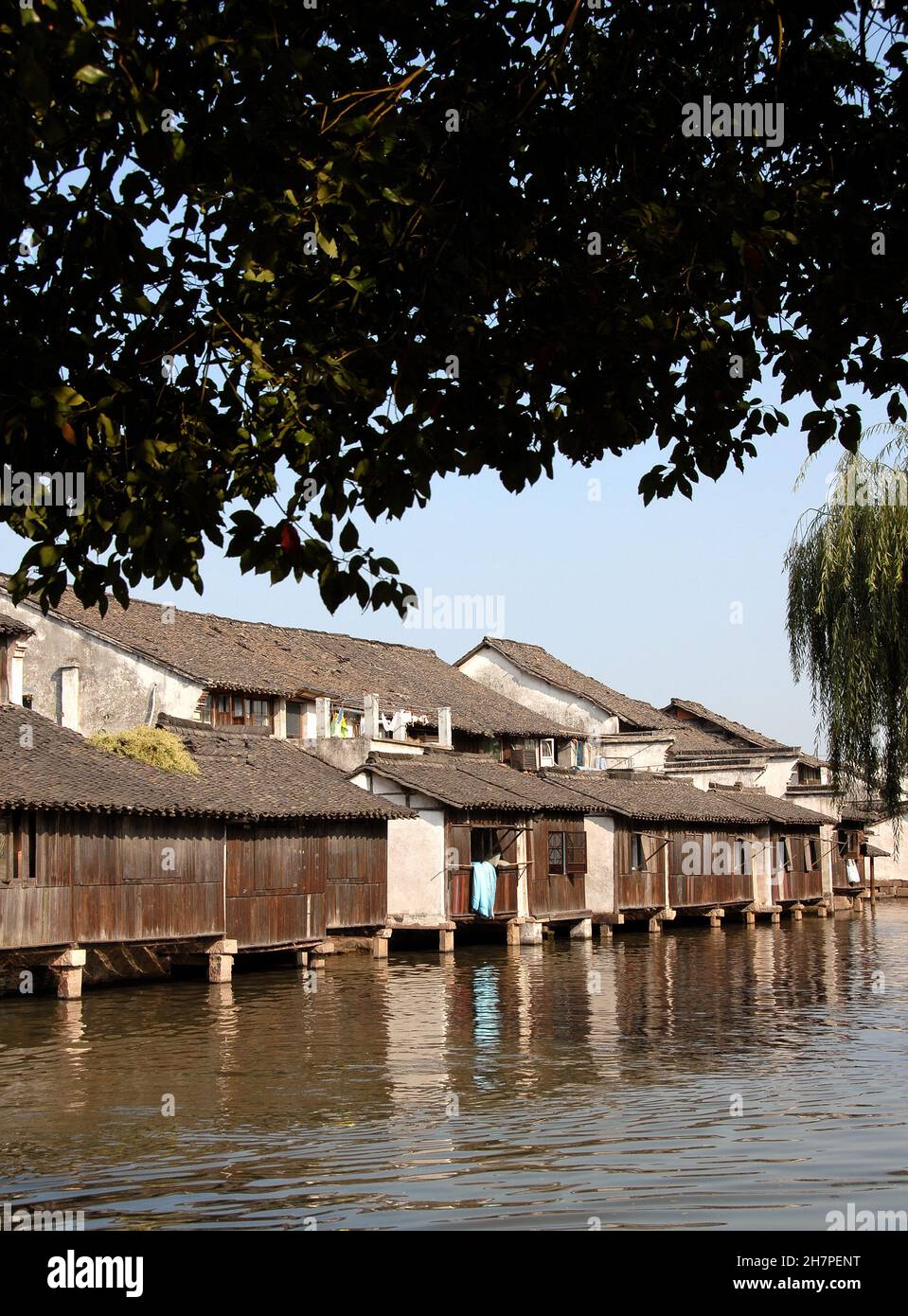 Wuzhen Water Town, Zhejiang Province, China. Traditional wooden houses beside a canal in the old Chinese town of Wuzhen. Stock Photo