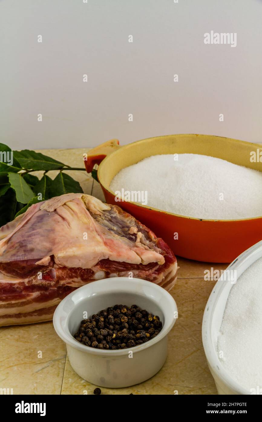 Pork loin or back joint with ingredients for dry curing into bacon