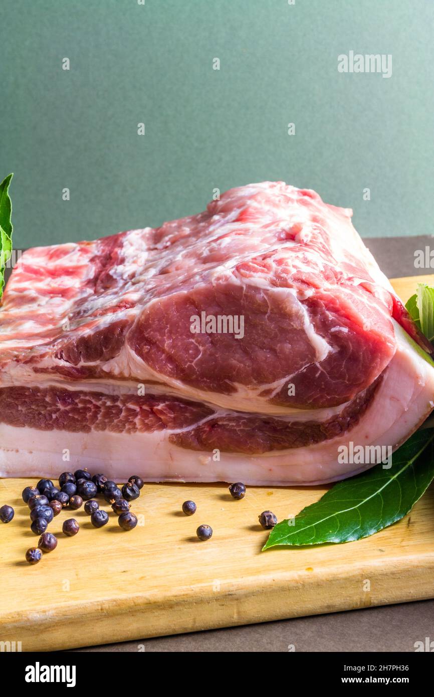 Pork loin or back joint with ingredients for dry curing into bacon