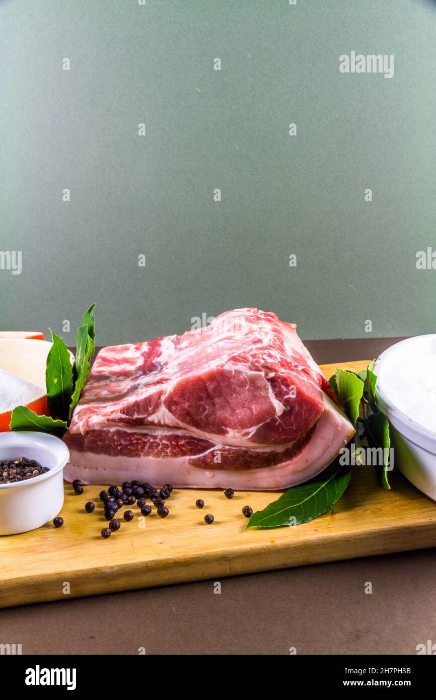 Pork loin or back joint with ingredients for dry curing into bacon