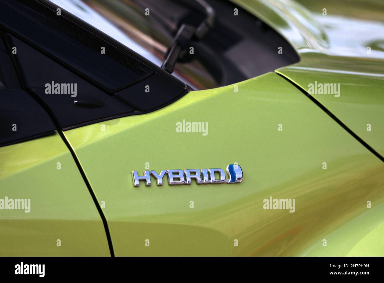 BARCELONA, SPAIN - OCTOBER 7, 2021: Hybrid marking on a Toyota car in Spain. Modern hybrid cars are partially powered by electricity. Stock Photo