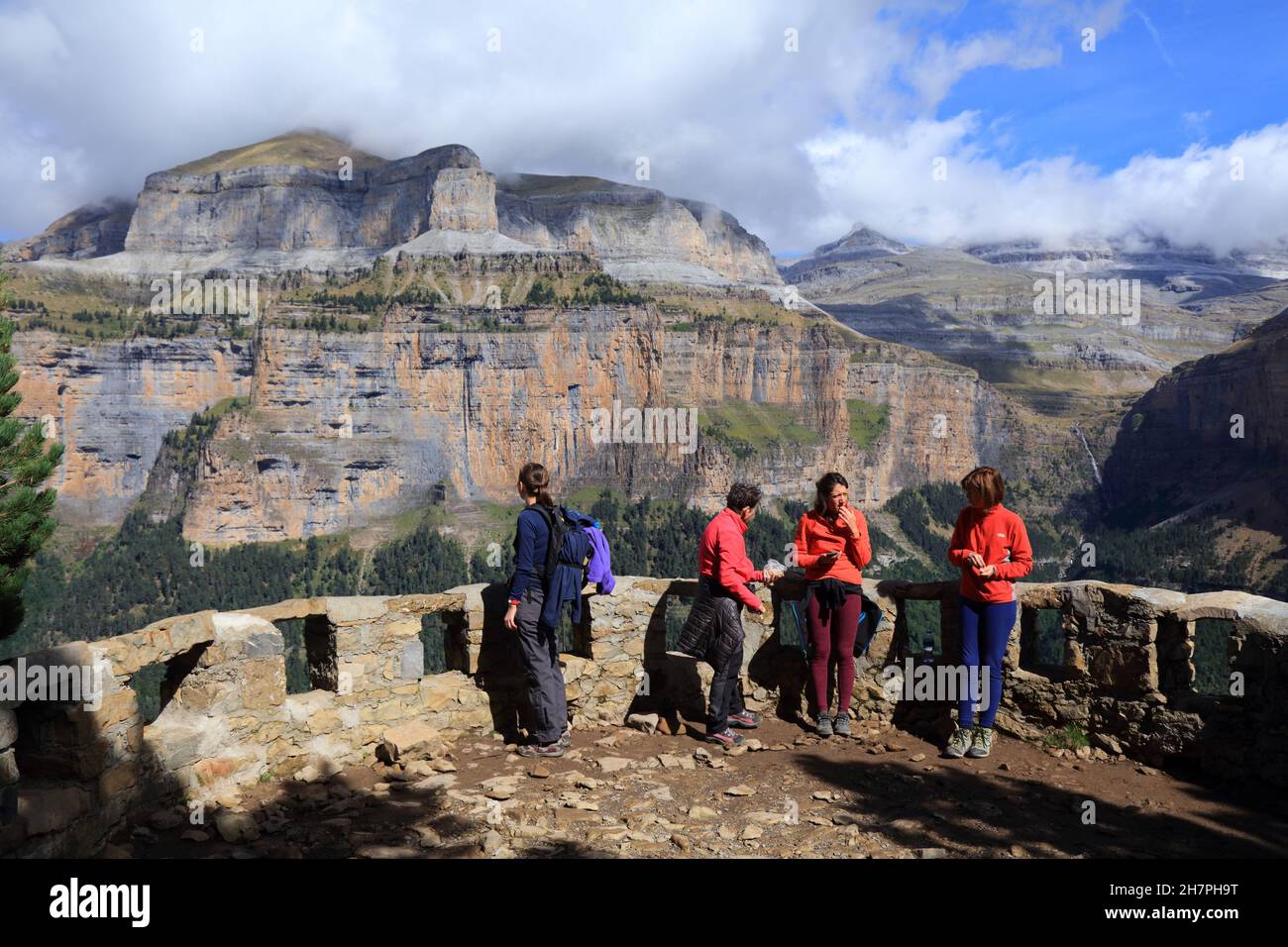 PYRENEES, SPAIN - SEPTEMBER 26, 2021: Hikers visit observation point along Senda de Los Cazadores hiking trail in Ordesa y Monte Perdido National Park Stock Photo