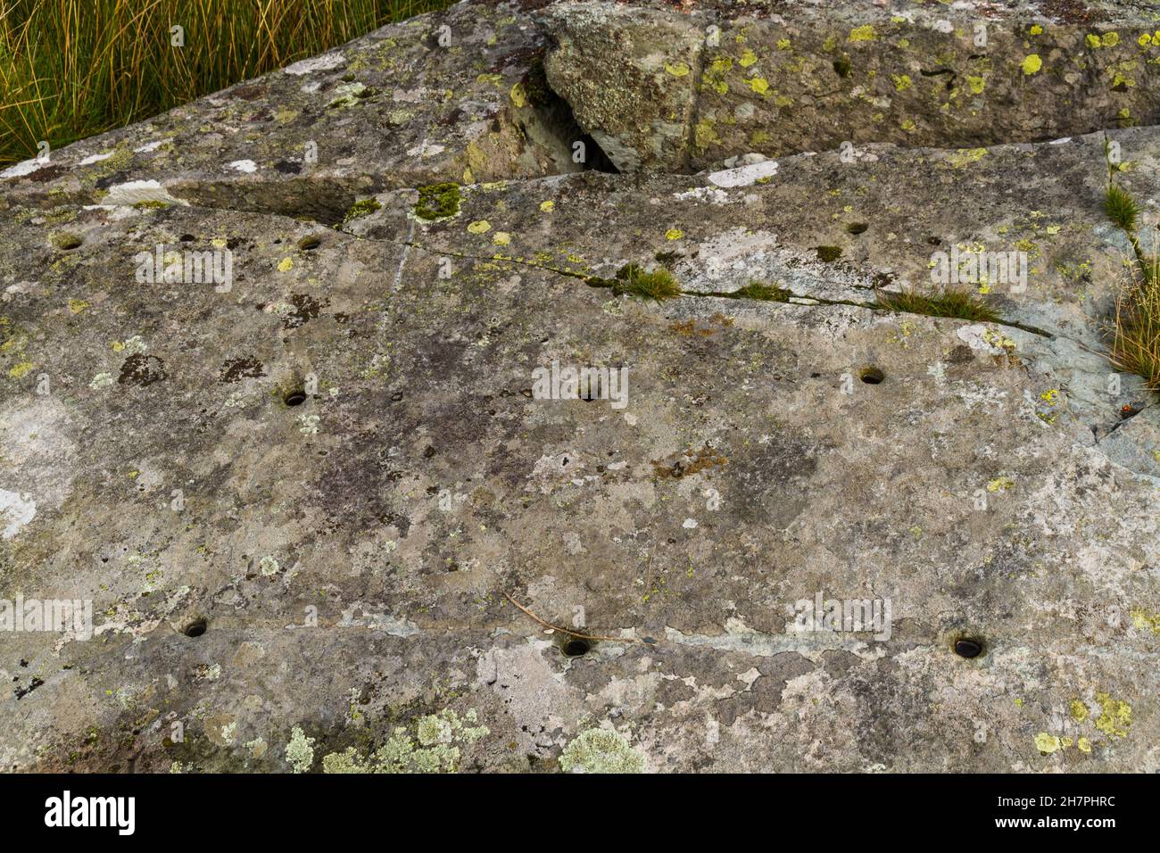 North Wales Rock Cannon, holes in rock or boulder. Gun powder used to make bangs in celebrations close up. Stock Photo