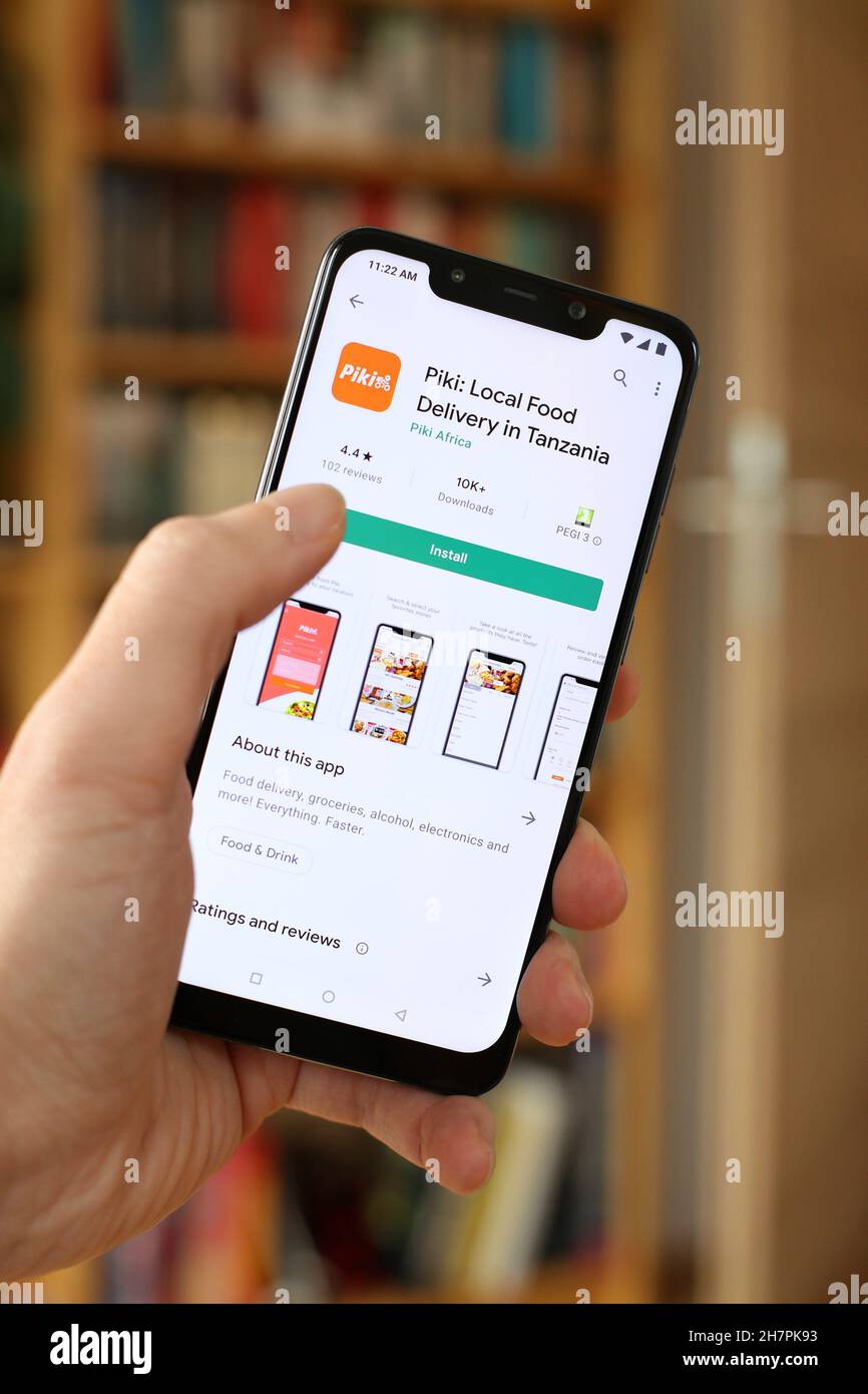 WARSAW, POLAND - JANUARY 29, 2021: User installing Piki food delivery startup app on an Android OS, Xiaomi brand smart phone. Piki is popular in Tanza Stock Photo