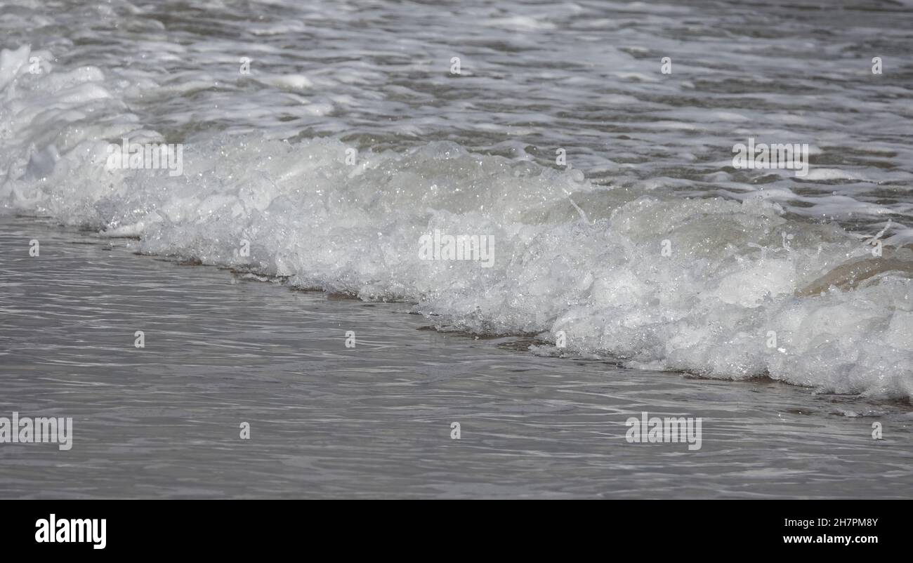Beautiful view of waves breaking on the beach Stock Photo - Alamy