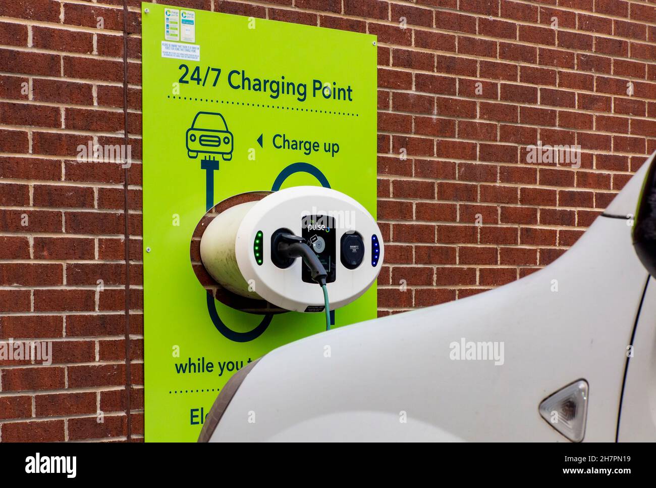 Electric vehicle charging point for cars outside a supermarket in
