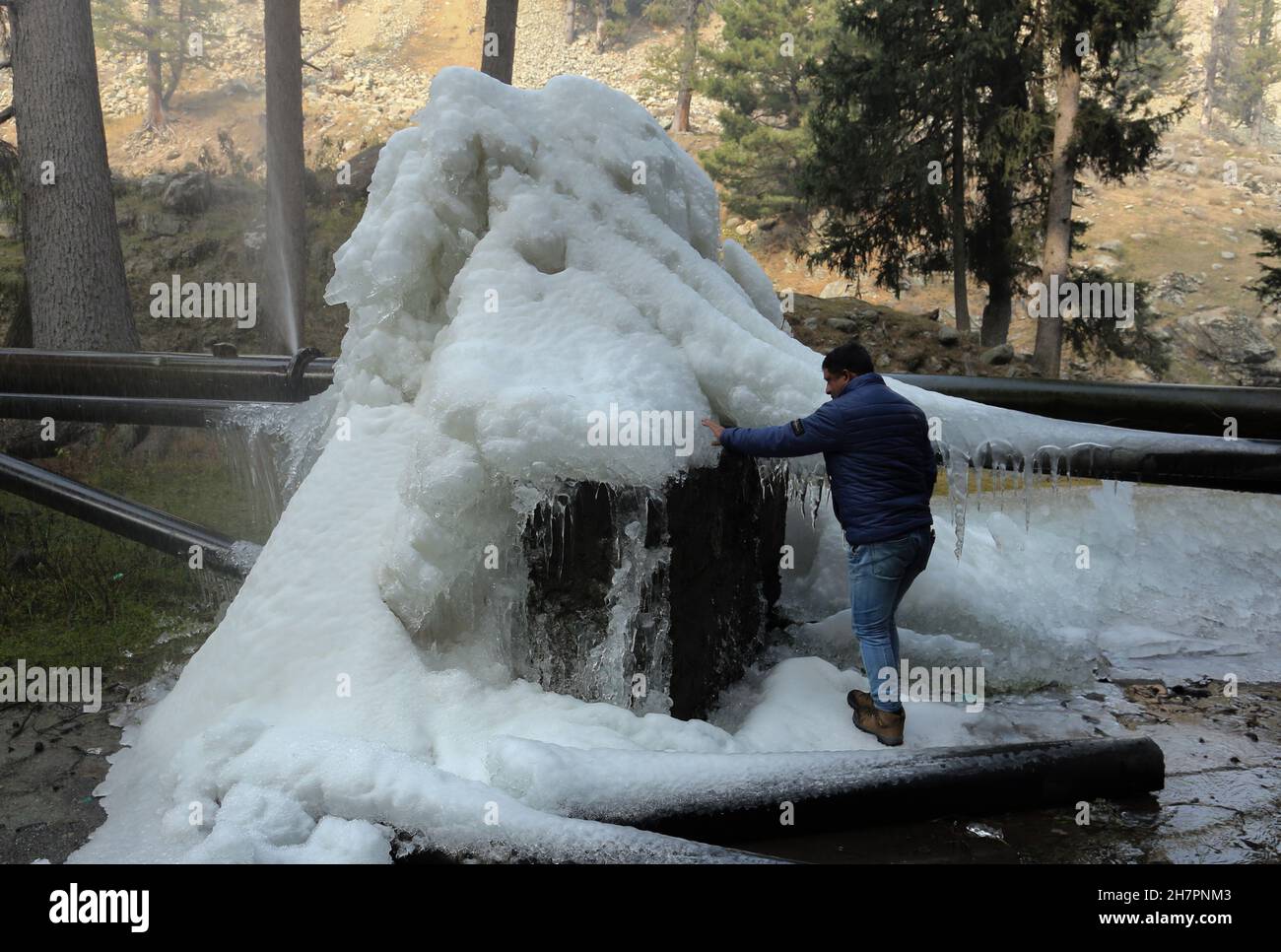 Srinagar, India. 24th November 2021. A Kashmiri man walks past Icicles