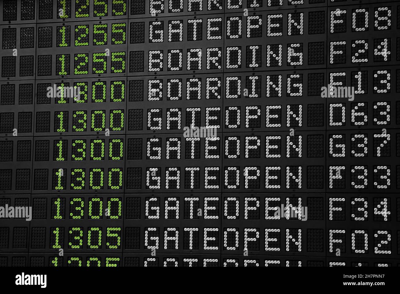 Flight information panel desk at airport, with time, flight number, boarding and gate open messages, close up, low angle view Stock Photo