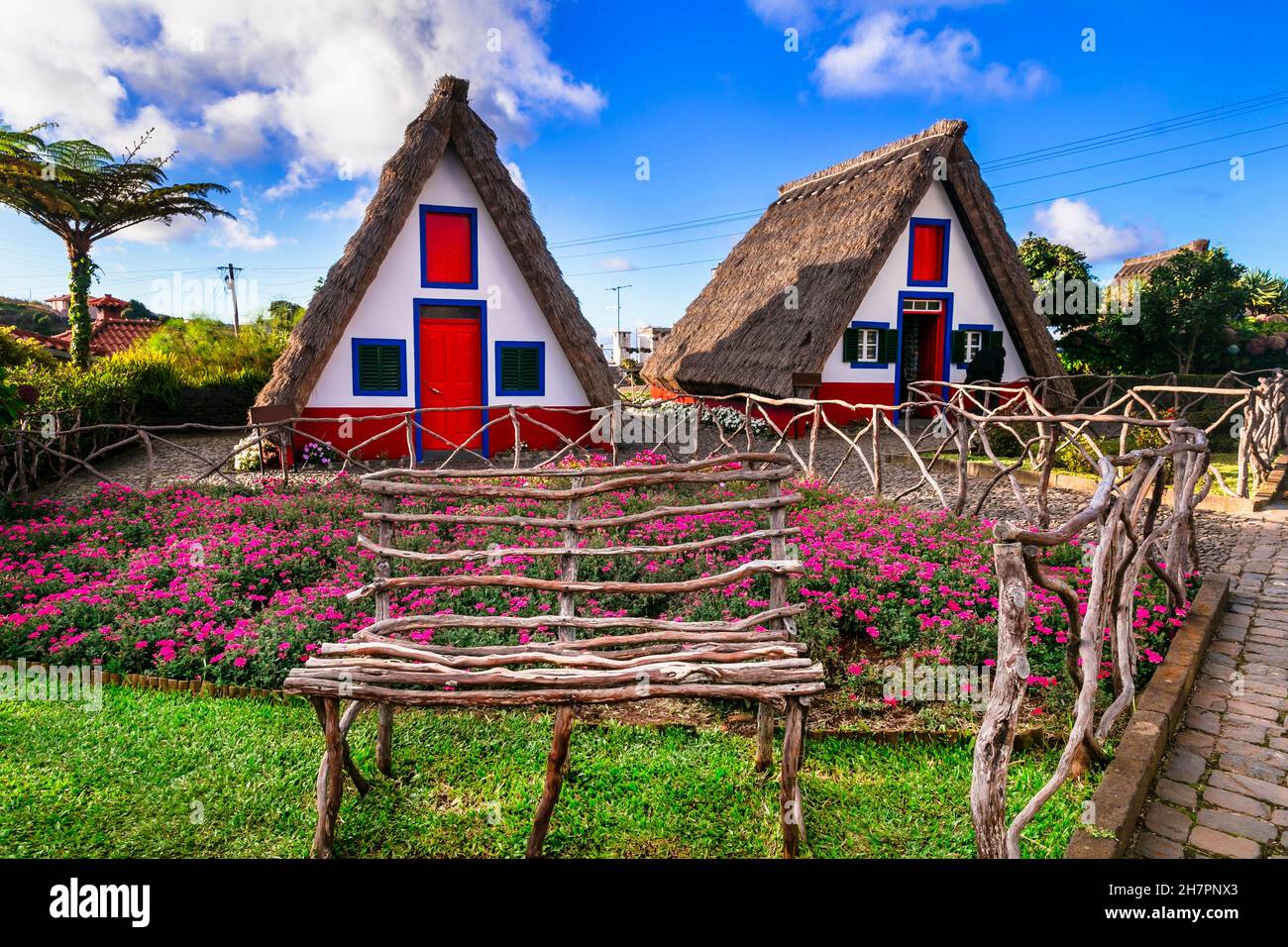 Madeira island travel and landmarks. Charming traditional colorful houses with thatched roofs in Santana town, popular tourist attraction in Portugal Stock Photo