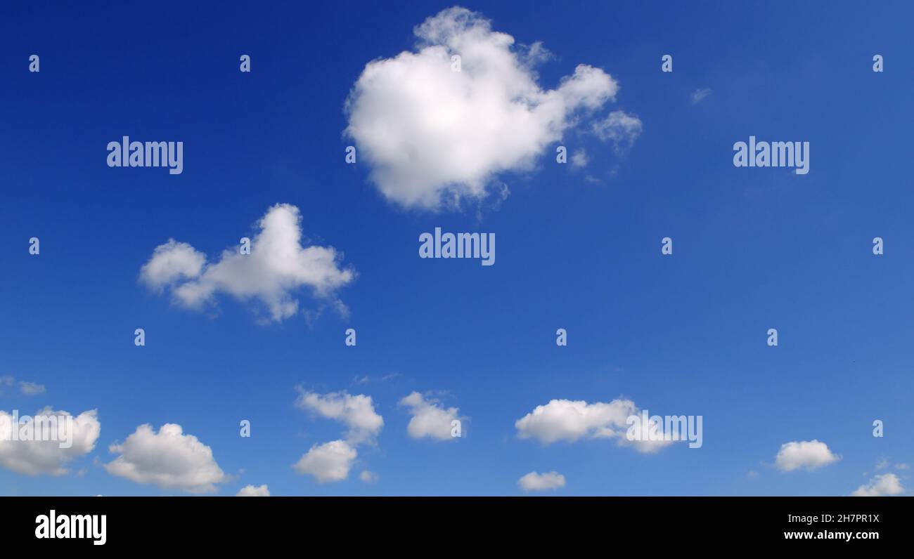 Light cumulus clouds in the blue sky. Wide photo Stock Photo - Alamy