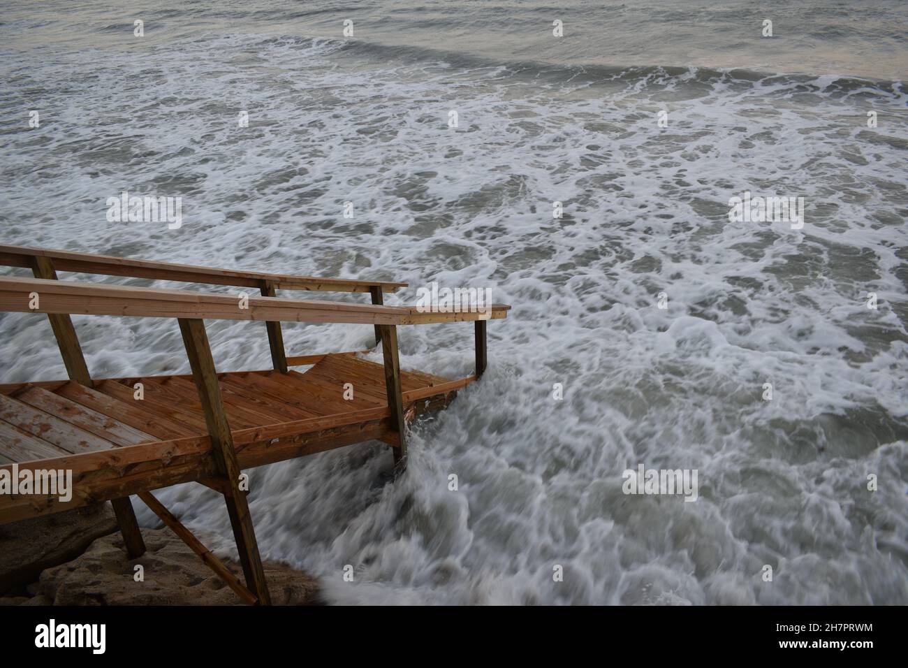 Flooding seawater damages the staircase. Stock Photo