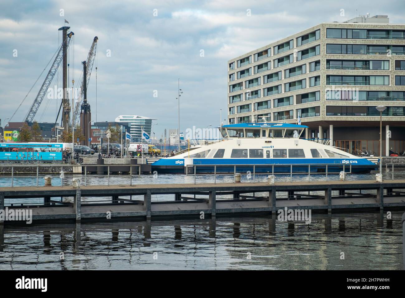 Passengers disembark from the city ferry connecting Amsterdam with North in front of The Pontsteiger apartment building in the western harbour area. Stock Photo