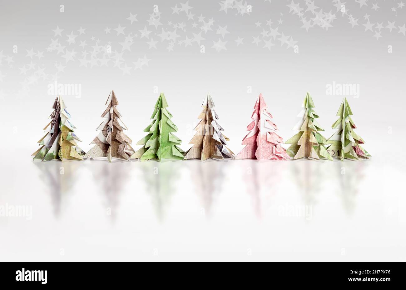 Origami Christmas trees made of paper money. Miniature Xmas trees